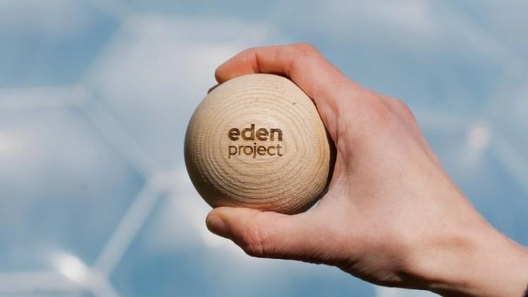 Hand holding wooden marble for giant marble run
