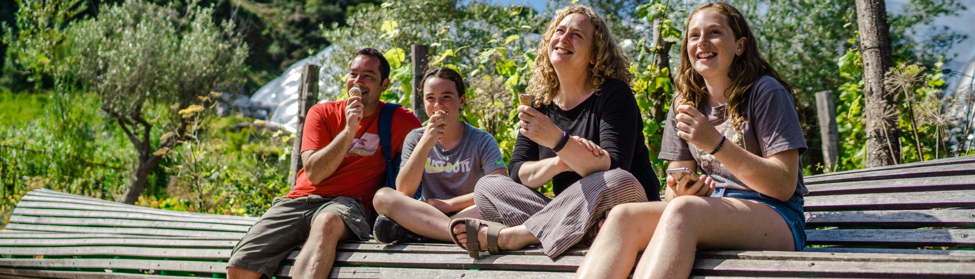 Family eating ice creams on bench at Eden Project