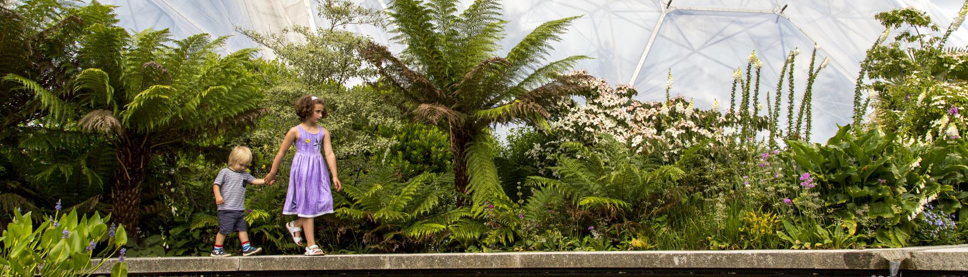 Boy and girl beside pond at Eden Project