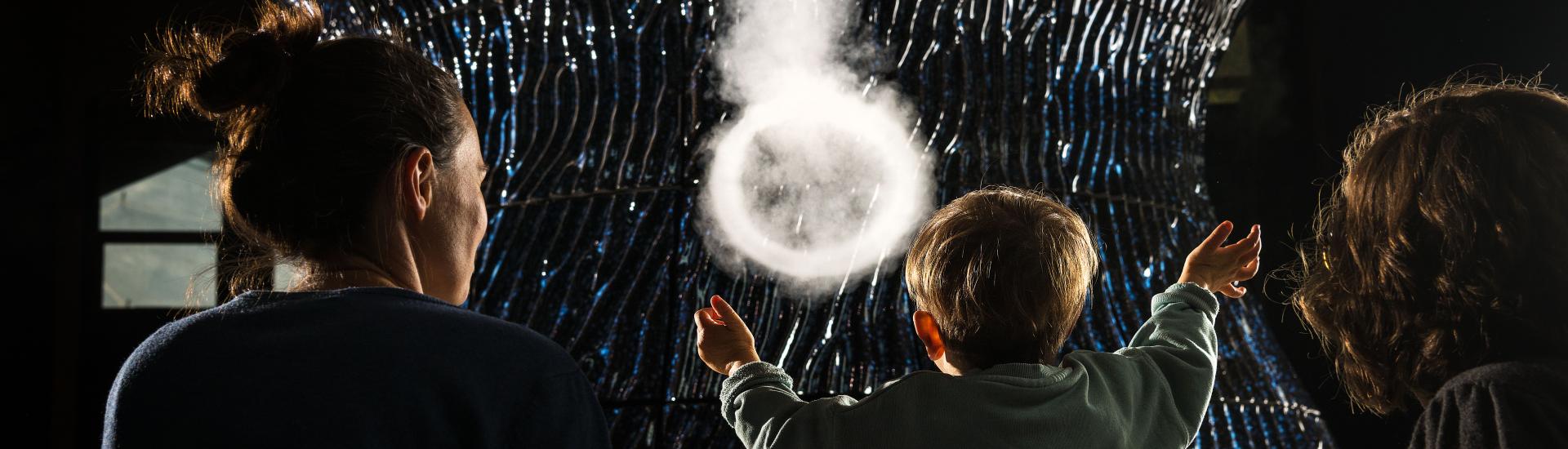 Child interacting with a sculpture at Eden