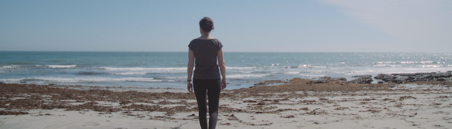 Lone woman walking on a beach