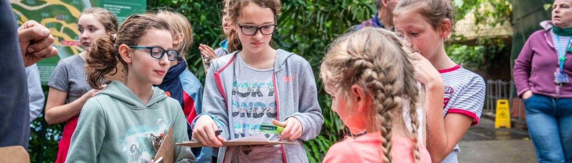 girls in rainforest with clipboards