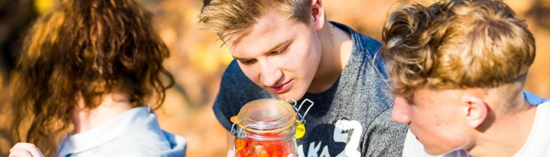 teens looking at a jar