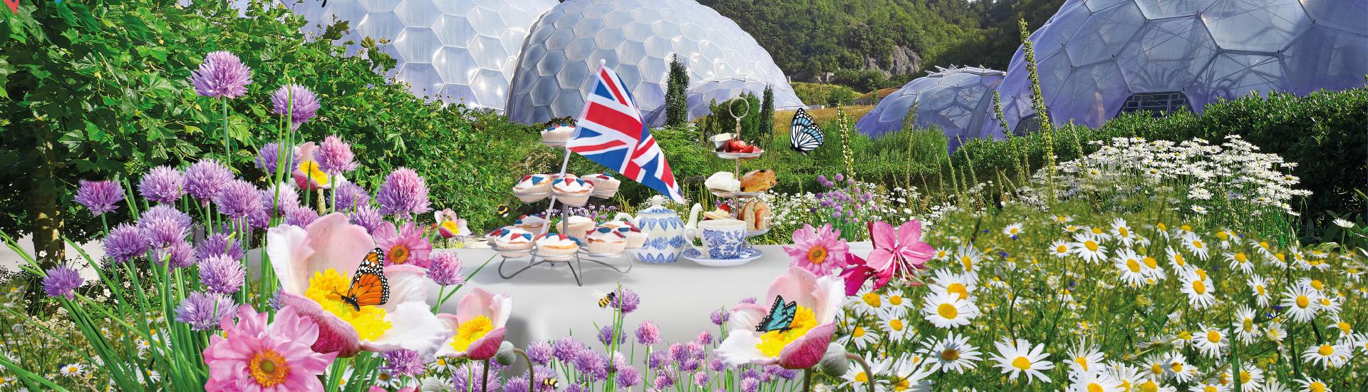 Eden Project Biomes with Jubilee lunch on a table surrounds by flowers, bees and butterflies