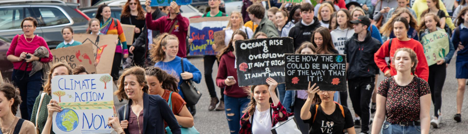 People holding placards with climate change messages on during a climate march