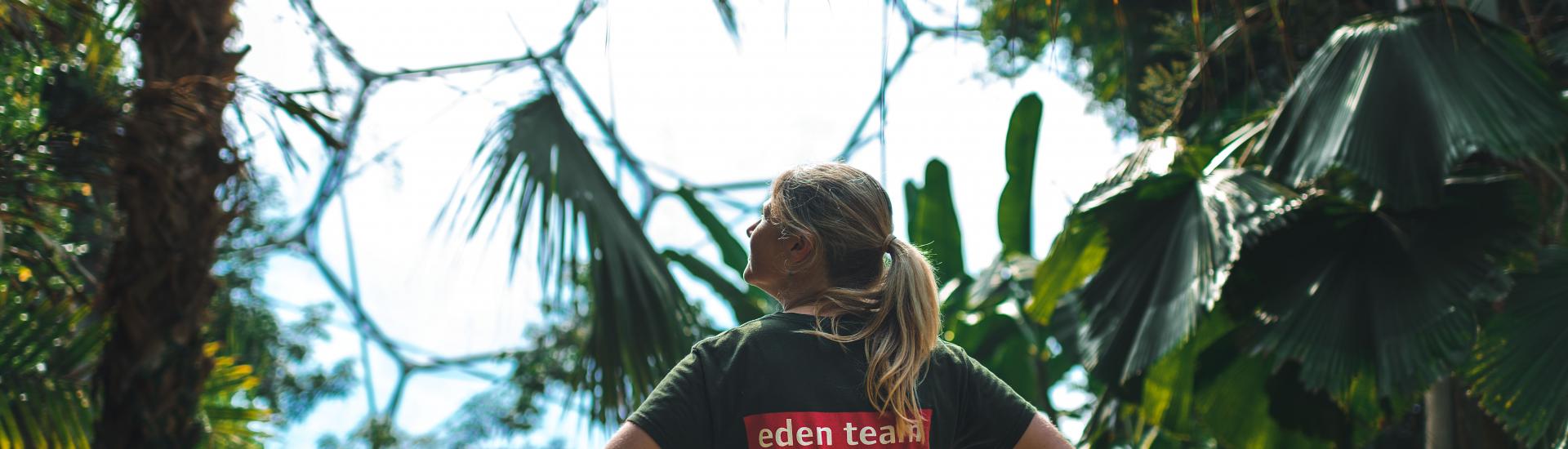 Eden staff member in Rainforest Biome standing with their hands on their hips