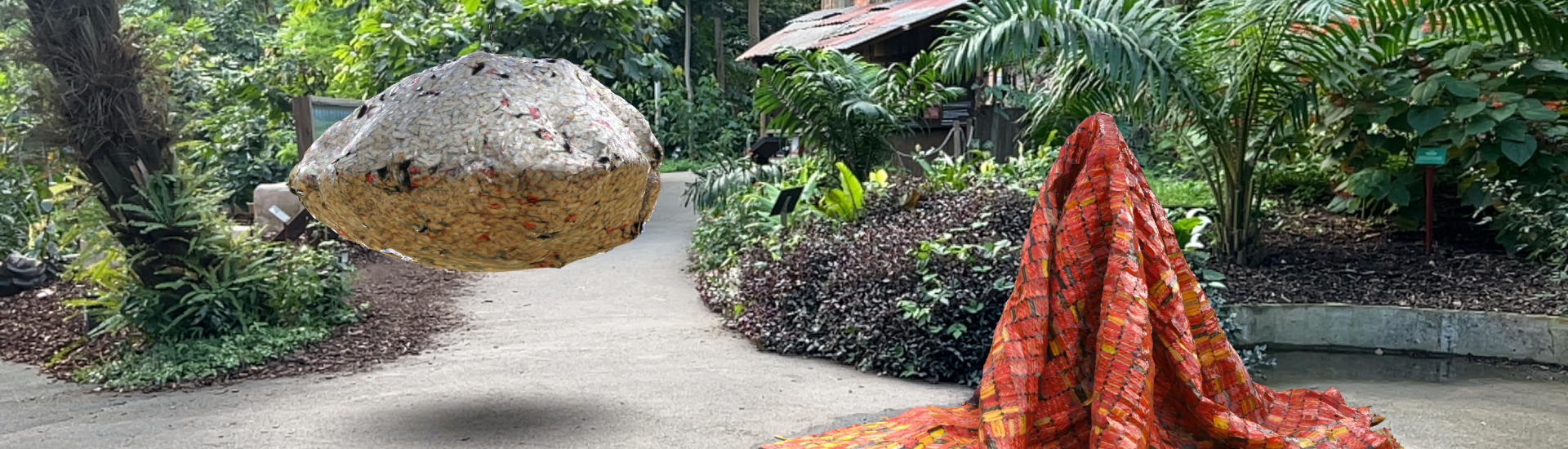 Augmented reality artwork in the Mediterranean Biome. The artwork resembles a floating rock like sculpture and a red and orange rug. 
