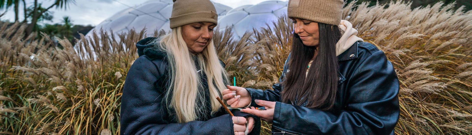 Teachers writing and dressed warmly outside at the Eden Project