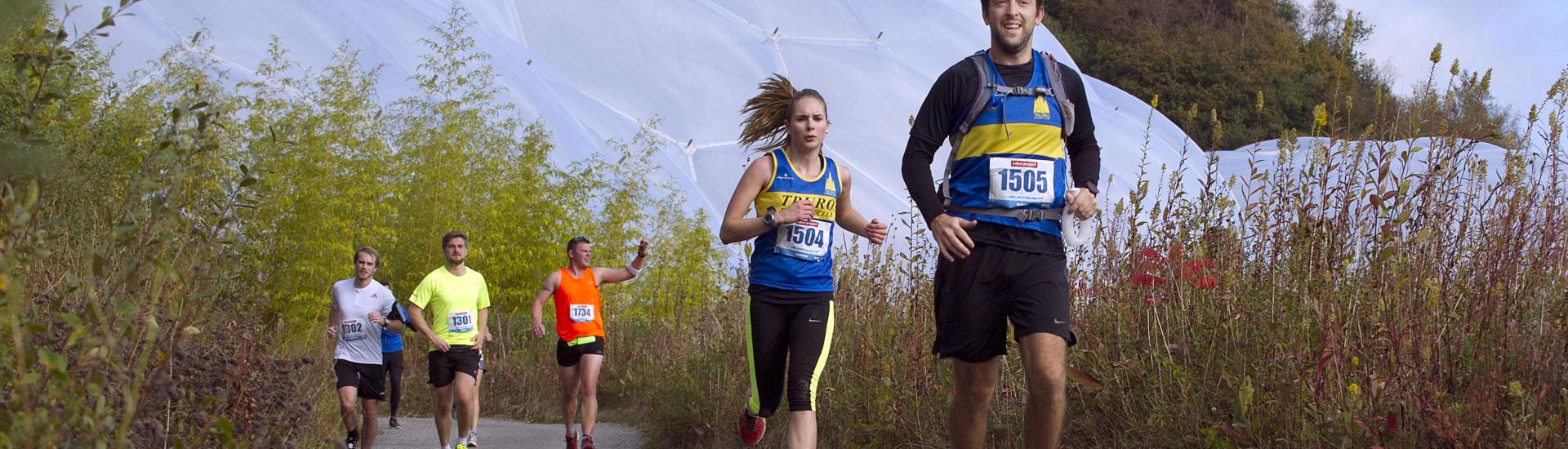 Runners in front of Eden's Biomes