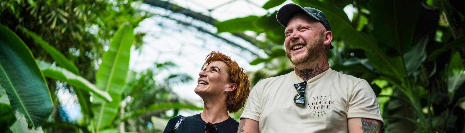 Couple holding hands and laughing in the Rainforest Biome