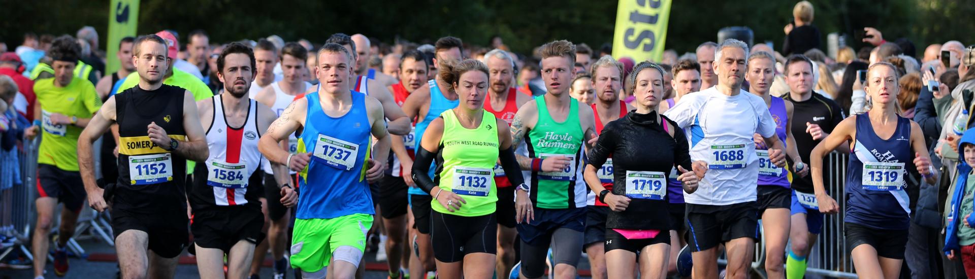 Group of runners passing the start line 