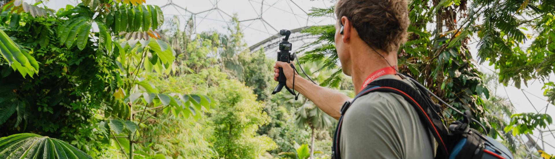 Robbie looks out over the Rainforest with his livestreaming equipment